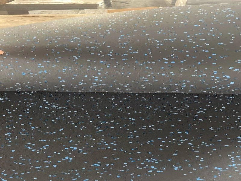 Close-up of a rubber flooring sample showing high density and even EPDM fleck distribution